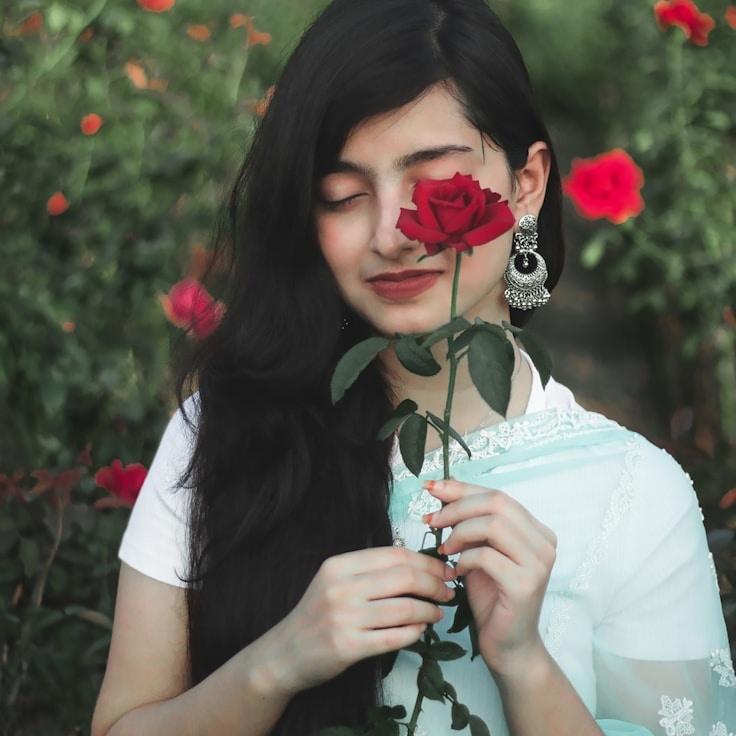 Avery Clarke, Lead Design Curator at Grove Paper Quay, reviewing corporate floral arrangements